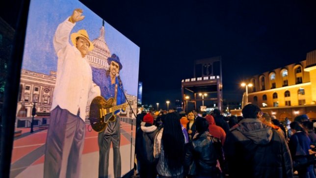 Oliver Johnson, Jr., holds an acrylic painting he did of former Mayor Marion Barry and Chuck Brown, during a vigil to honor former Mayor and current DC City Council member Marion Barry, Sunday, Nov. 23, 2014, in Washington
